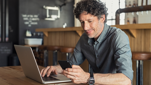 Mature Businessman Working At Cafe