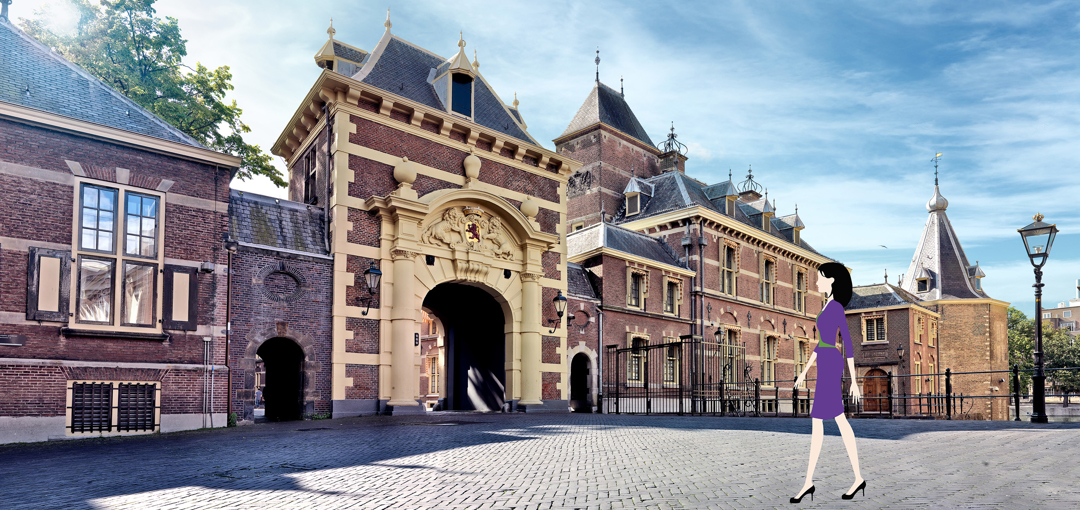 Evi van Lanschot, gekleed in een paarse jurk, wandelt voor het Binnenhof in Den Haag.